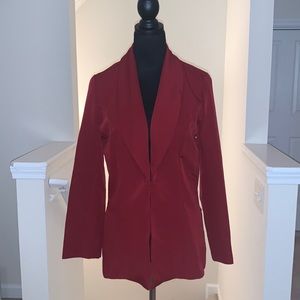 Chic burgundy top with front closure. Styled by IMAN.